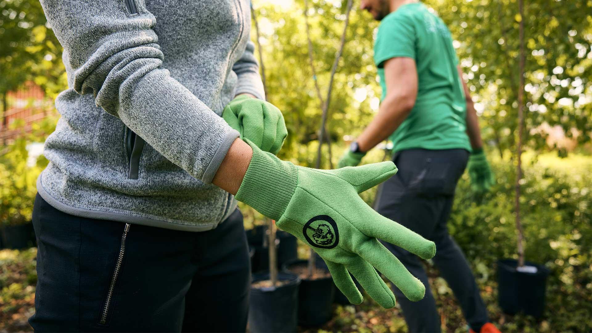 planting partner putting on Arbor Day Foundation gloves